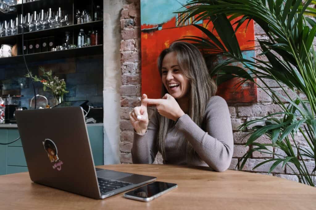A woman communicates via sign language on a webcam.