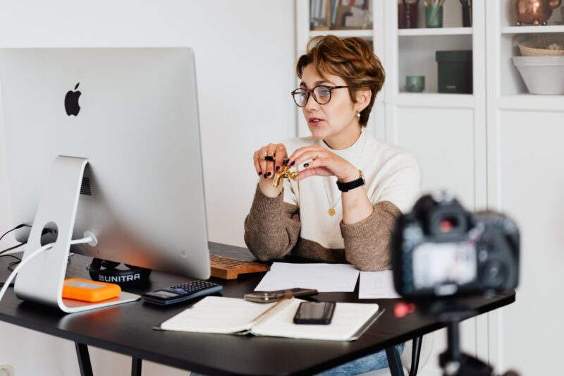 Woman with short hair giving a speech to a screen