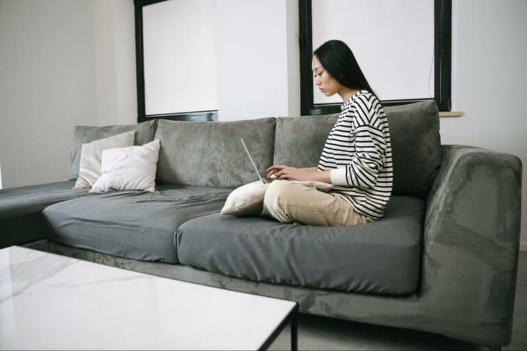 woman working from home, sitting on sofa