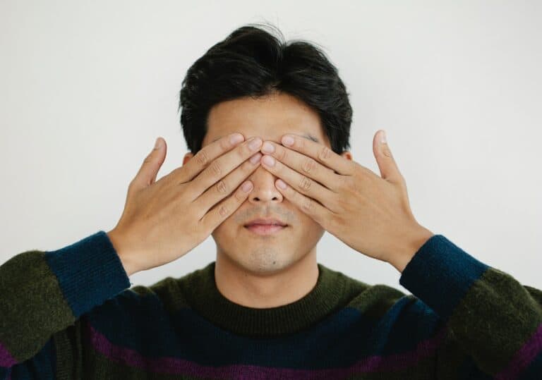 Man covering his eyes with his hands