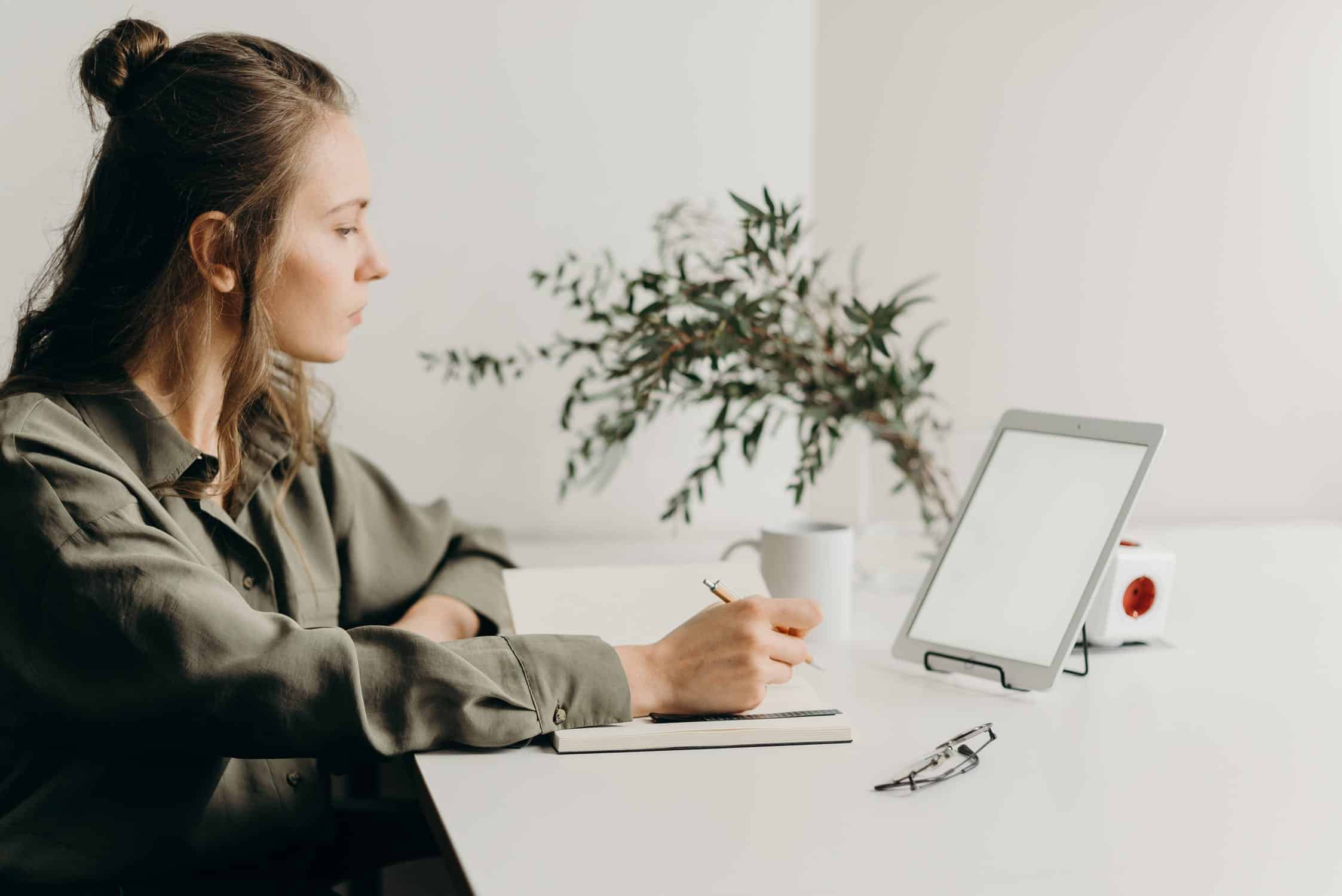 Woman on a desk working on her computer.