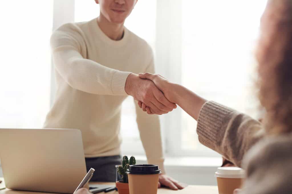 Man and woman shaking hands as they close a deal