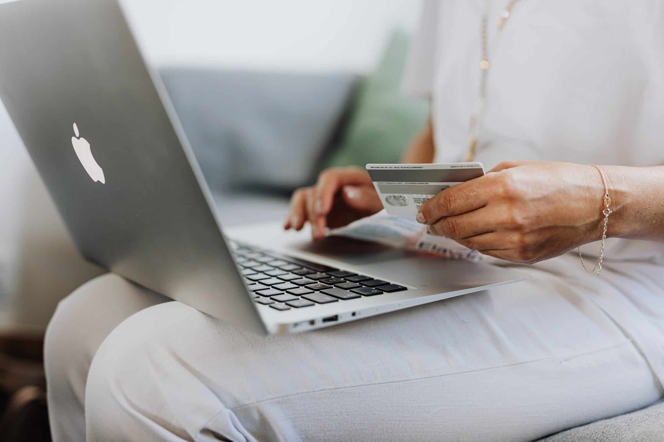 Hands on a laptop with a creditcard about to purchase something