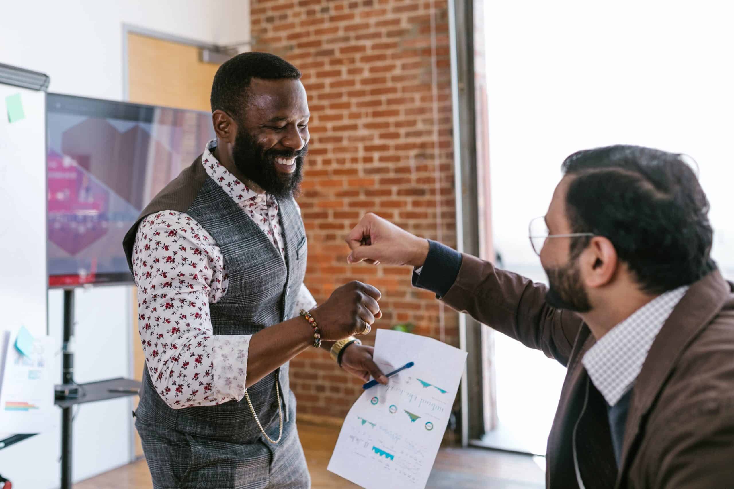 Two colleagues fist bumping