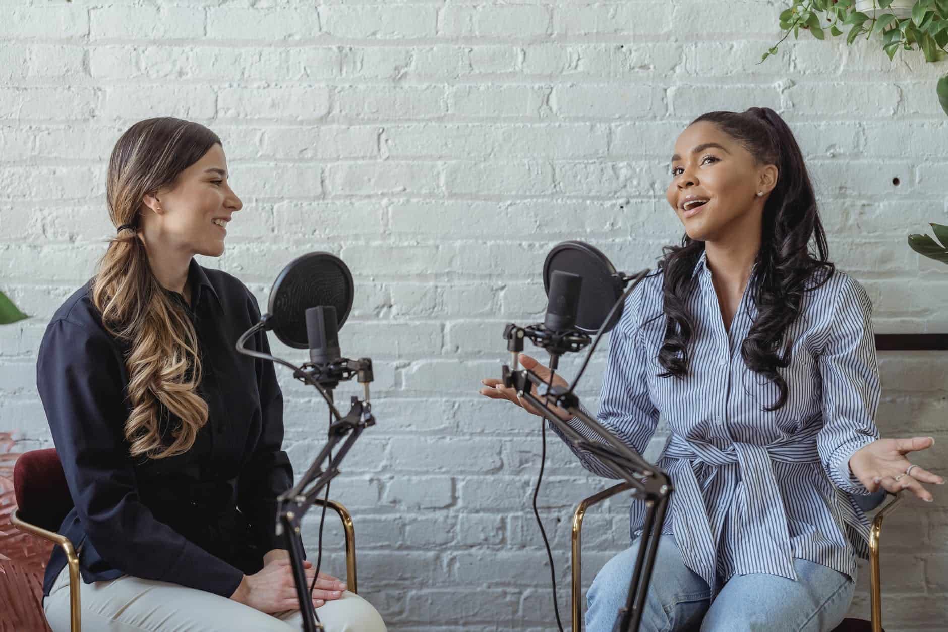 two women speaking into microphones