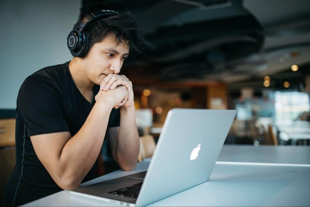 A man staring at an apple laptop