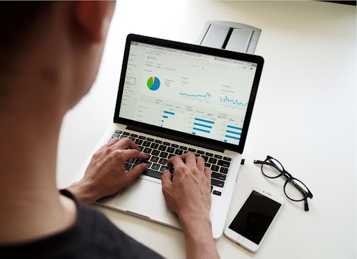 A guy operating a MacBook computer